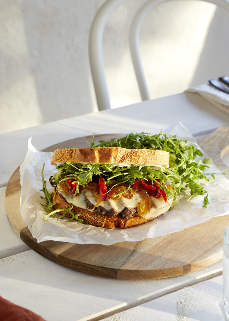 sweet + tangy steak sandwich, filled with filet mignon, grilled red peppers, provolone cheese, caramelized onions, garlic aioli + dressed arugula served on sourdough bread