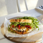 sweet and tangy steak sandwich with garlic aioli, caramelized onions, arugula, provolone and grilled red peppers