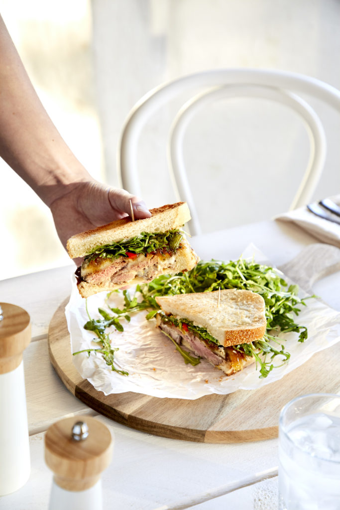 sweet + tangy steak sandwich, filled with filet mignon, grilled red peppers, provolone cheese, caramelized onions, garlic aioli + dressed arugula served on sourdough bread